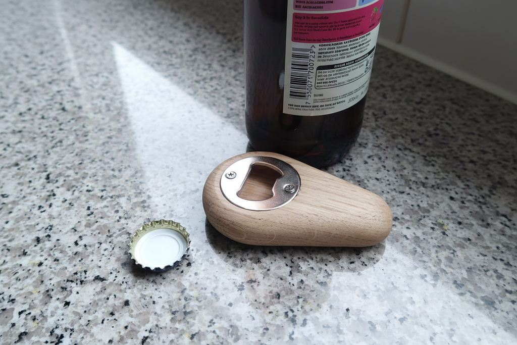 Wooden bottle opener on granite countertop